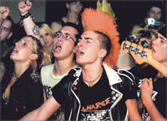 Right, an audience member sings into the microphone at a Blind Society punk rock concert at the El 'n' Gee Club in New London.