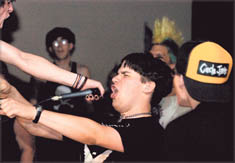 Freddie Stevens, front center, sings along with other audience members while The Virus, a punk rock band from Pennsylvania, plays at the El 'n' Gee Club.